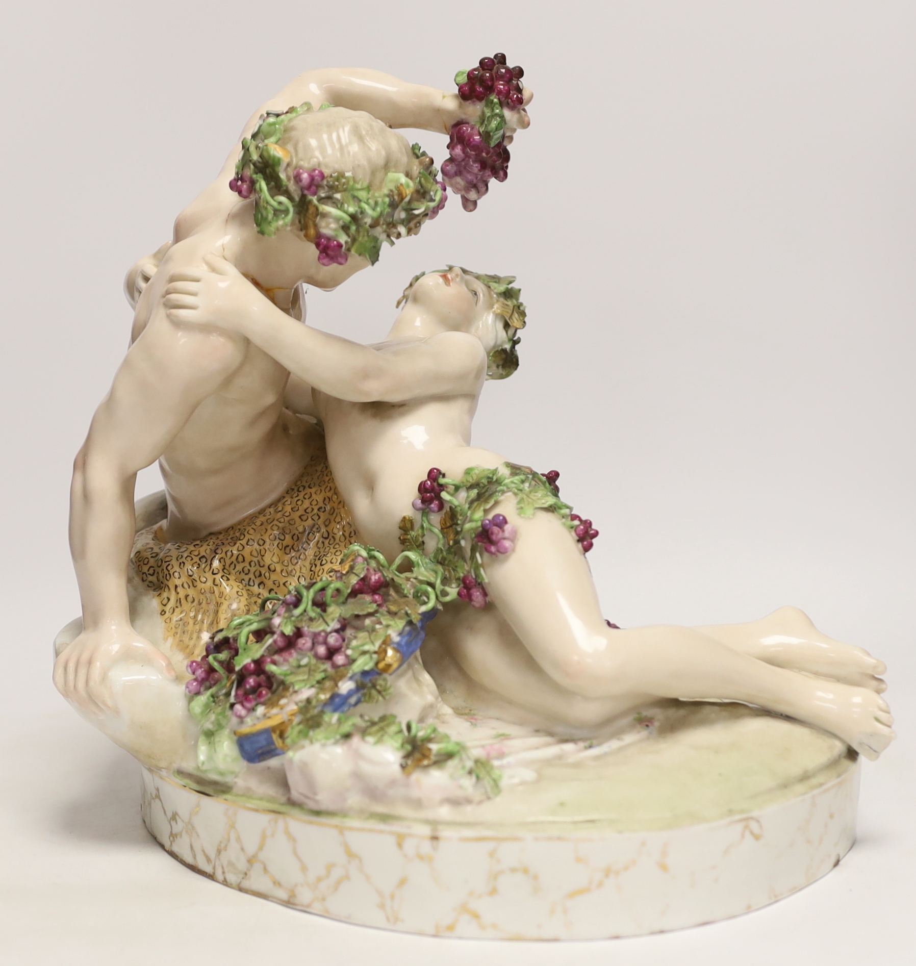 A large German porcelain Bacchus group, pseudo Meissen cross swords mark, 29cm high